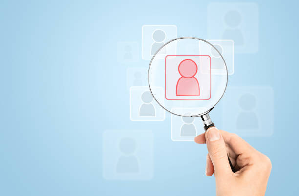 istock hand with a magnifying glass looking for the desired holographic icon 2160867424