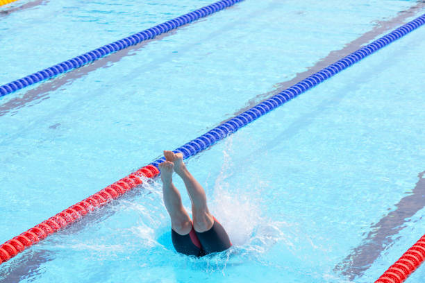 istock male swimmer jumping in a swimming pool 2160870841