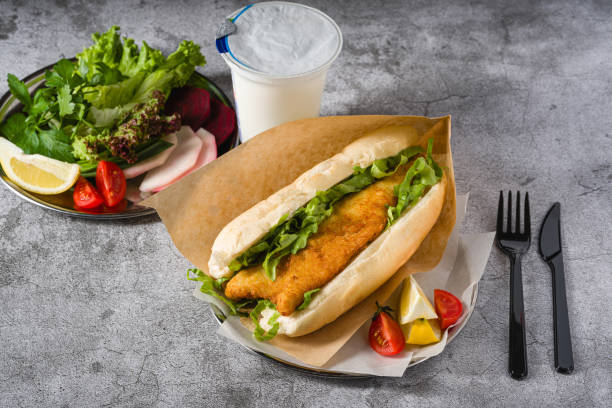 istock Fried fish sandwich with greens on the stone table. Turkish name Balik Ekmek 2160871648