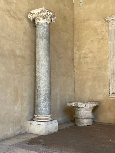 istock Decorated Ionic column with leaf pattern on volutes and a Doric capital on the ground beside 2160874502
