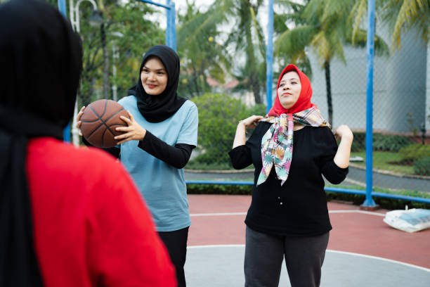istock Coach giving practice example to basketball team during practice in gym 2160878088