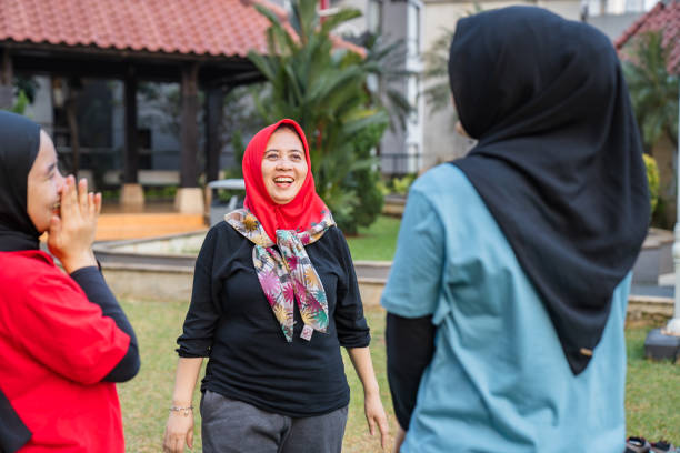 Yoga practice exercise class concept. Fitness women beginning yoga practice with private teacher on park. Working out with professional female yogi instructor. Healthy lifestyle in fitness club