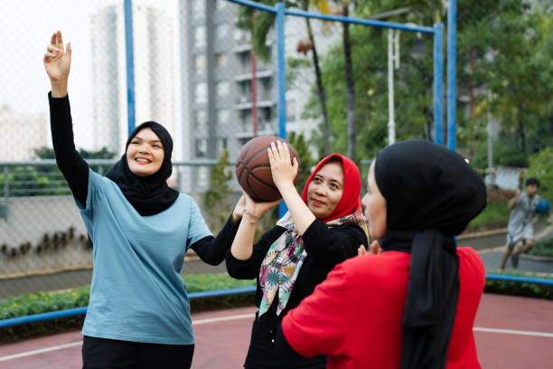 istock Coach giving practice example to basketball team during practice in gym 2160878909