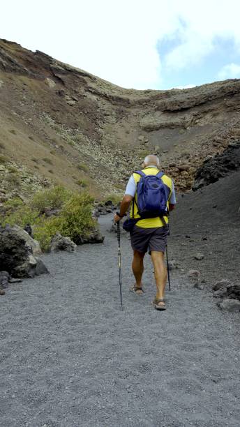 istock Explorer over 70 years old entering the volcano crater 2160880892