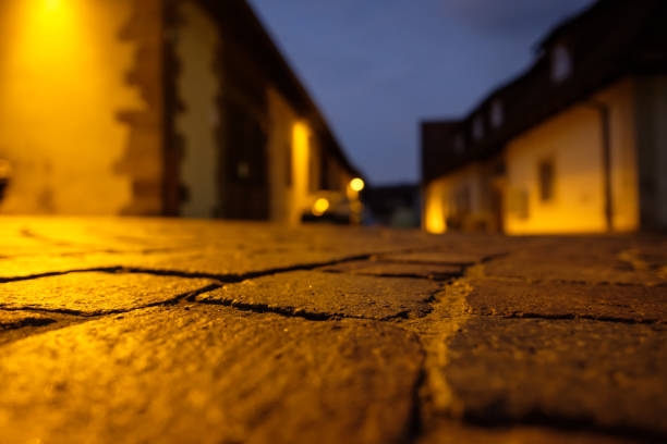 Close-up cobblestone street in dawn in yellow light