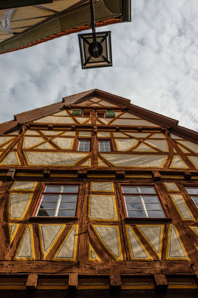 istock Half-timbered house in vertical format with street lamp 2160883217