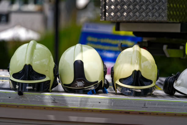 Close-up of helmets in a row at fire engine truck at town square named Schwamendinerplatz at Swiss City of Zürich on a sunny summer day. Photo taken July 6th, 2024, Zurich, Switzerland.