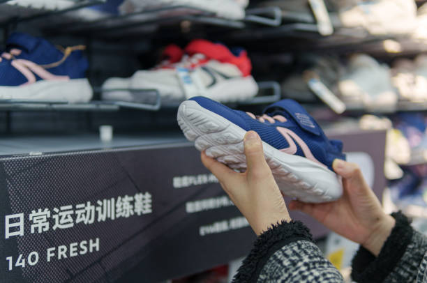 istock Mother selects shoes for child 2160886188