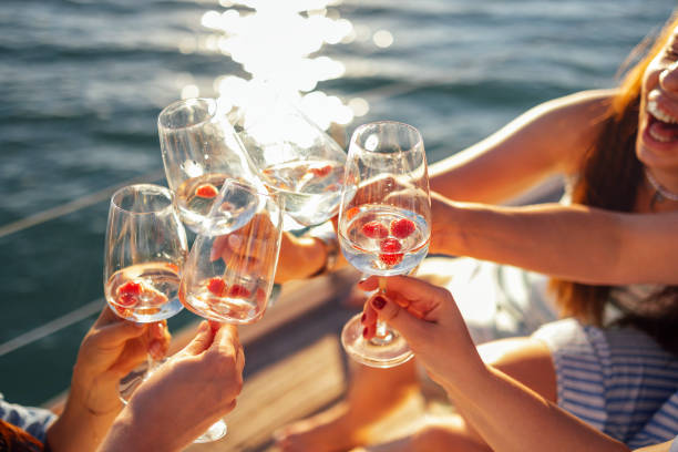 istock Sunset sky and sea on the background. Making a celebratory toast with sparkling wine 2160890475