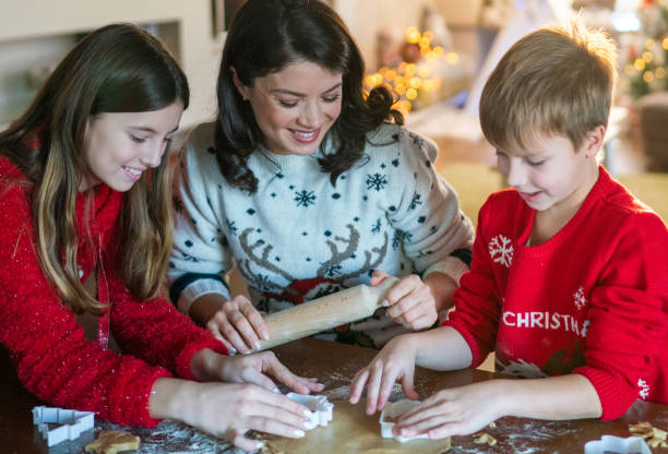 istock Woman making cookies whit her two children 2160890760
