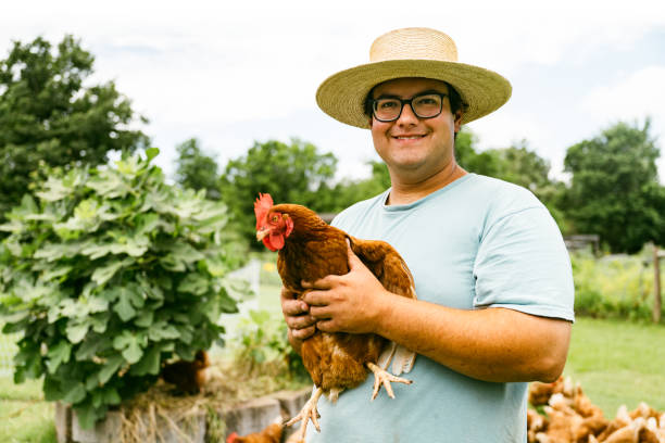 istock Farmer portrait holding a chicken 2160892421