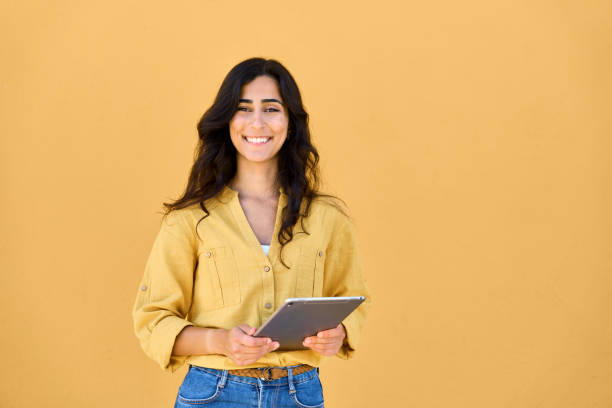 istock Middle eastern brunette female student girl working online using web application app on tablet for elearning, studying, communicating. Portrait of young woman holding digital pad computer isolated 2160892540