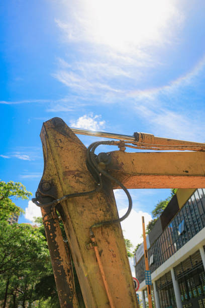 Worn Yellow Excavator Bucket in Sunny Day Setting