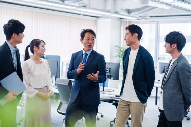 istock Business people standing around in an office 2160903089