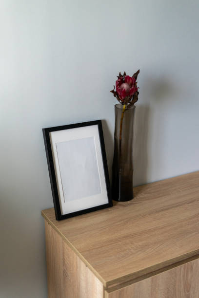 istock empty photo frame and a pink flower 2160904318