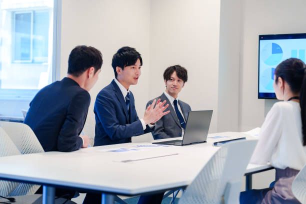 istock Young man in a suit speaking at a conference 2160904363