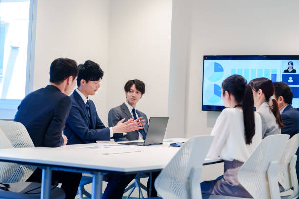 istock Young man in a suit speaking at a conference 2160904365