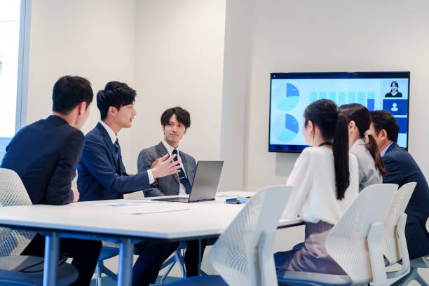 istock Young man in a suit speaking at a conference 2160904370