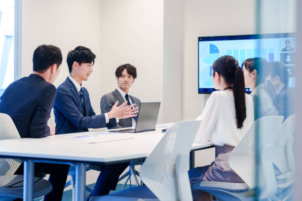 istock Young man in a suit speaking at a conference 2160904372