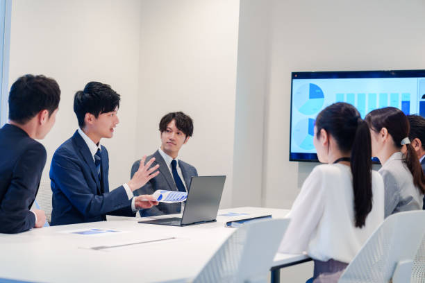 istock Young man in a suit speaking at a conference 2160904373