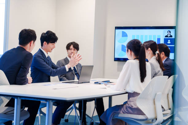 istock Young man in a suit speaking at a conference 2160904376