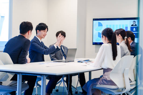 istock Young man in a suit speaking at a conference 2160904377