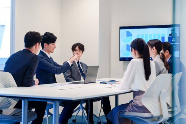 istock Young man in a suit speaking at a conference 2160904378