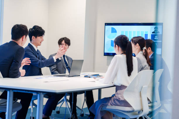 istock Young man in a suit speaking at a conference 2160904380