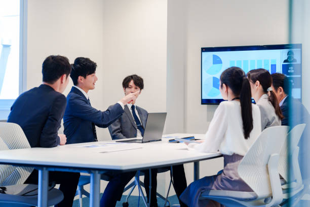 istock Young man in a suit speaking at a conference 2160904381