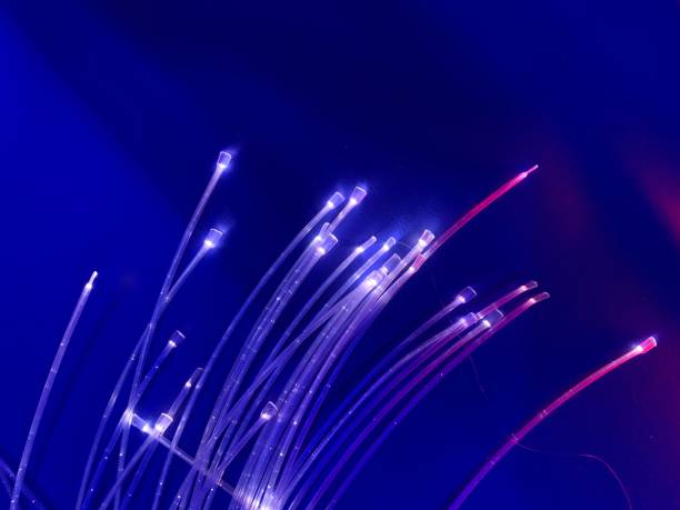 White and red Fibre optic cables with a blue background, close up
