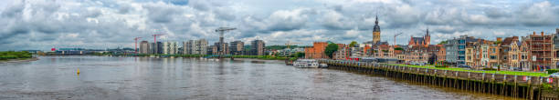 istock Temse Skyline - Cityscape With River and Cloudy Sky 2160907870