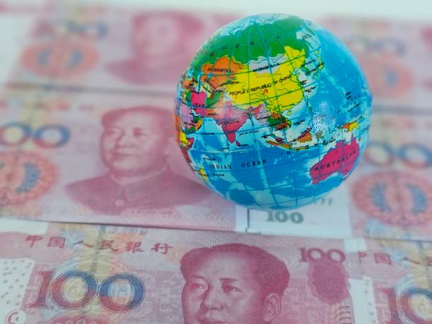 istock A Colorful Globe Resting on Chinese Yuan Banknotes 2160908089