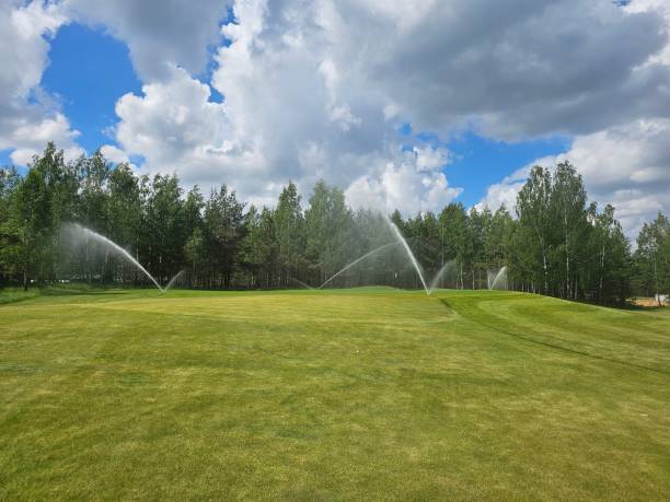 istock Sprinklers Watering a Golf Course on a Sunny Day 2160908150