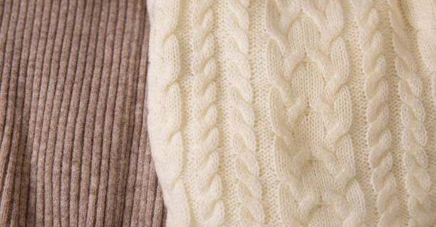 istock Pile of knitted warm sweaters clothes close up 2160908311