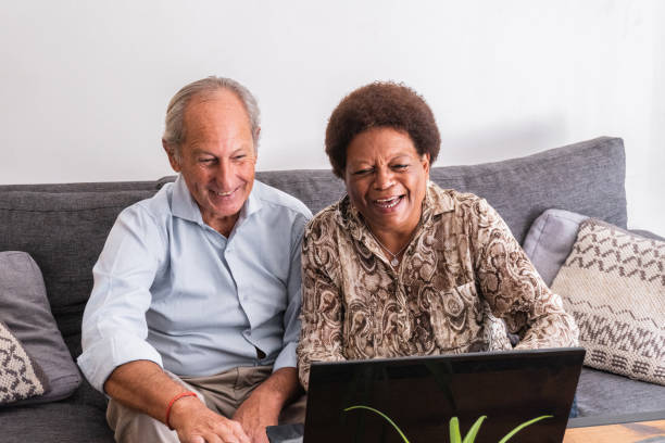 istock Senior couple using laptop at home 2160908391