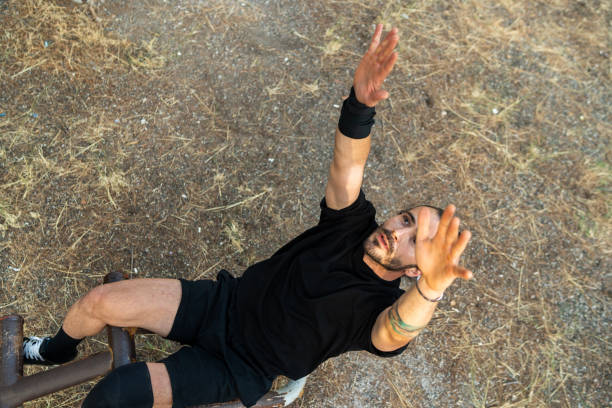 An open-air professional athlete performing calisthenic movements in the forest