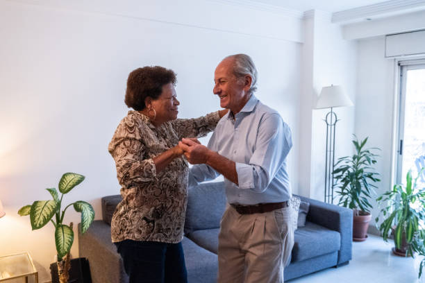 istock Senior couple dancing at home 2160908450