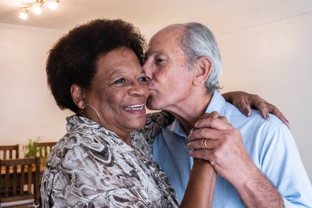 loving old african couple hugging outdoors, endless love, senior citizens lifestyle