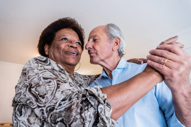Senior couple dancing at home
