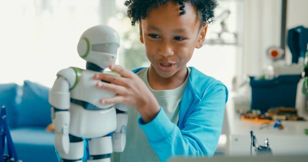 Closeup of Young African-American boy meticulously assembles and adjusts robotic arm, showcasing his engagement with STEM learning in home workshop. STEM Education robotics courses online concept.
