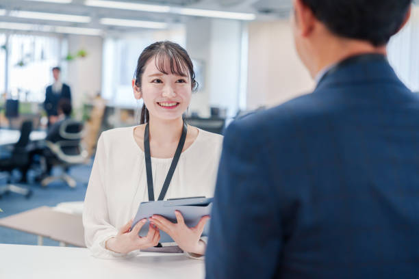Female staff handling visitors at the counter.