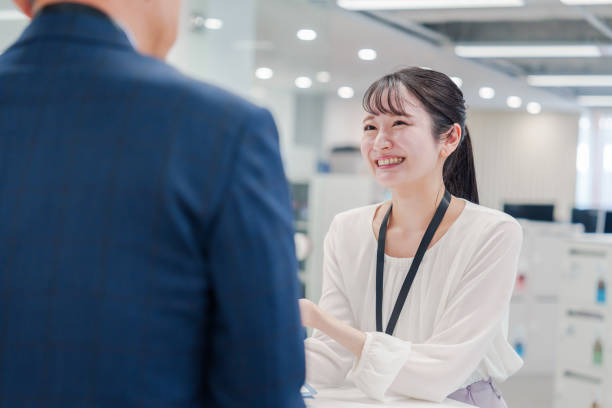 istock Female staff handling visitors at the counter. 2160910432