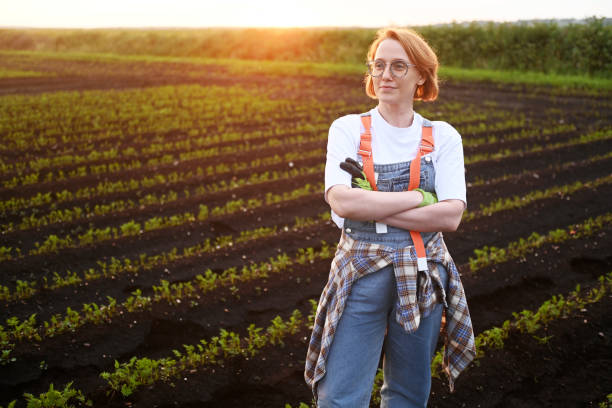 istock female farmer against the backdrop of agricultural fields 2160912053