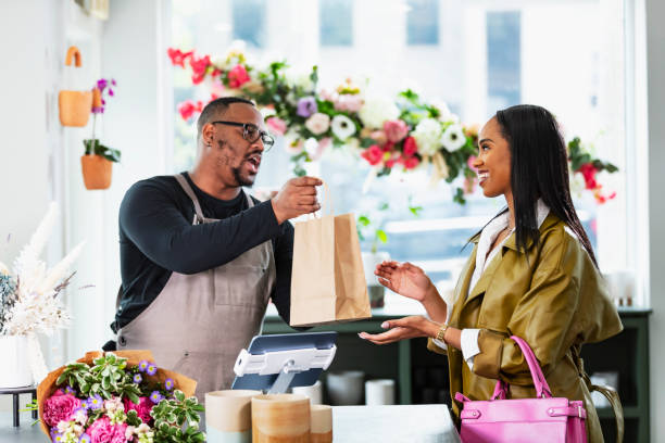 istock African-American man in gift shop, customer at checkout 2160915047