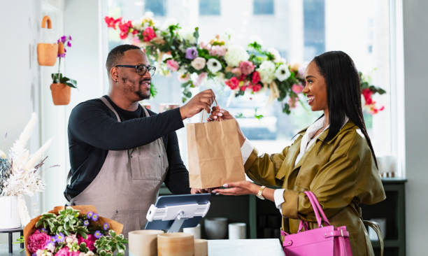 istock African-American man in gift shop, customer at checkout 2160915048