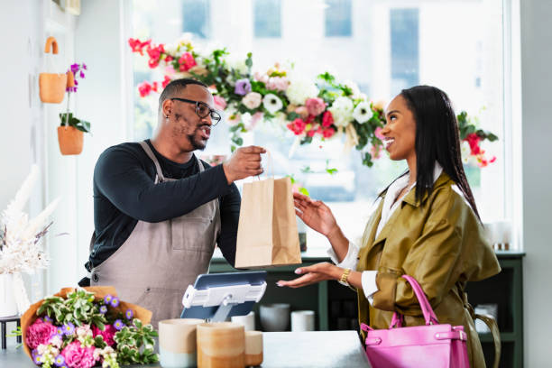 istock African-American man in gift shop, customer at checkout 2160915052