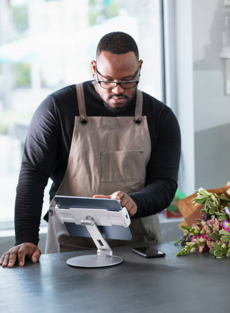 istock Small business owner entering customer order on tablet 2160915103