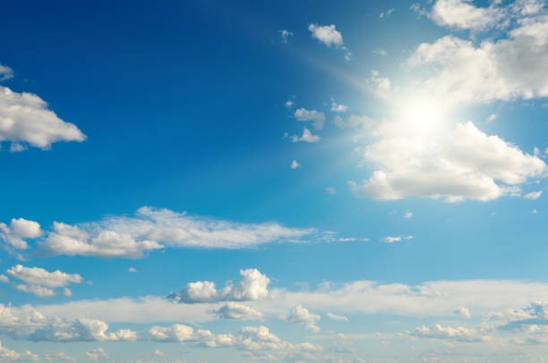 istock Bright sun on beautiful blue sky with white clouds. 2160918942