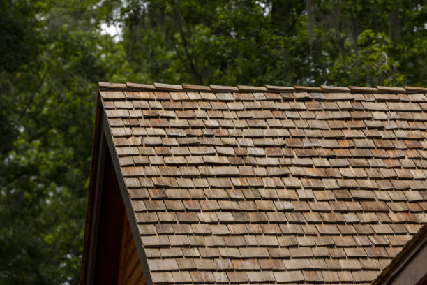 istock New cedar roof with ridge cap over gable end, with forest in the background 2160919394