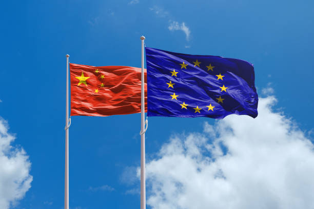 EU and China flags above blue sky. China and Europe Union trade war. EU and China flags above blue sky. China and Europe Union trade war. EU dutys for EV cars made in China china digital flag stock pictures, royalty-free photos & images